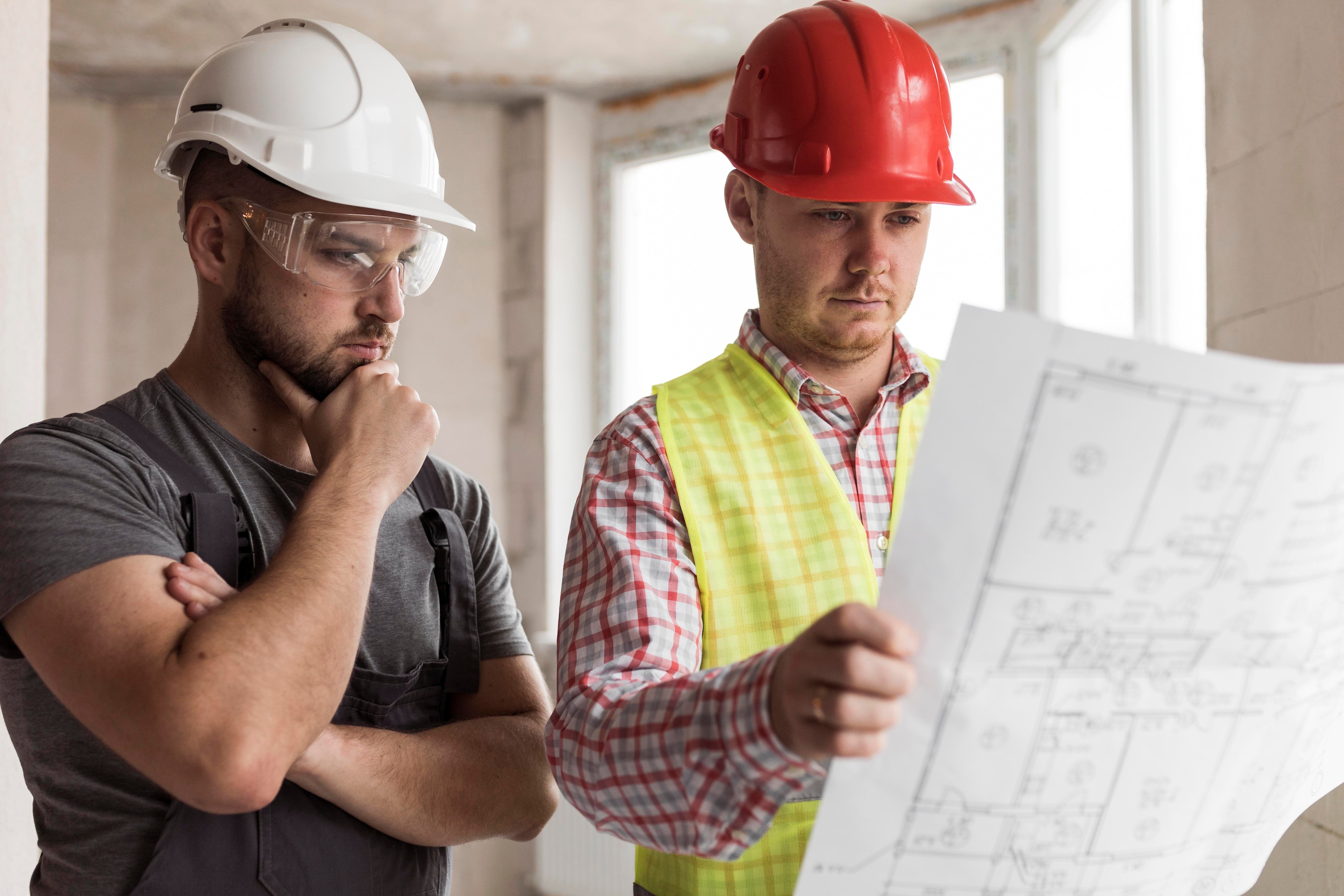 Construction professionals reviewing a building model and plans